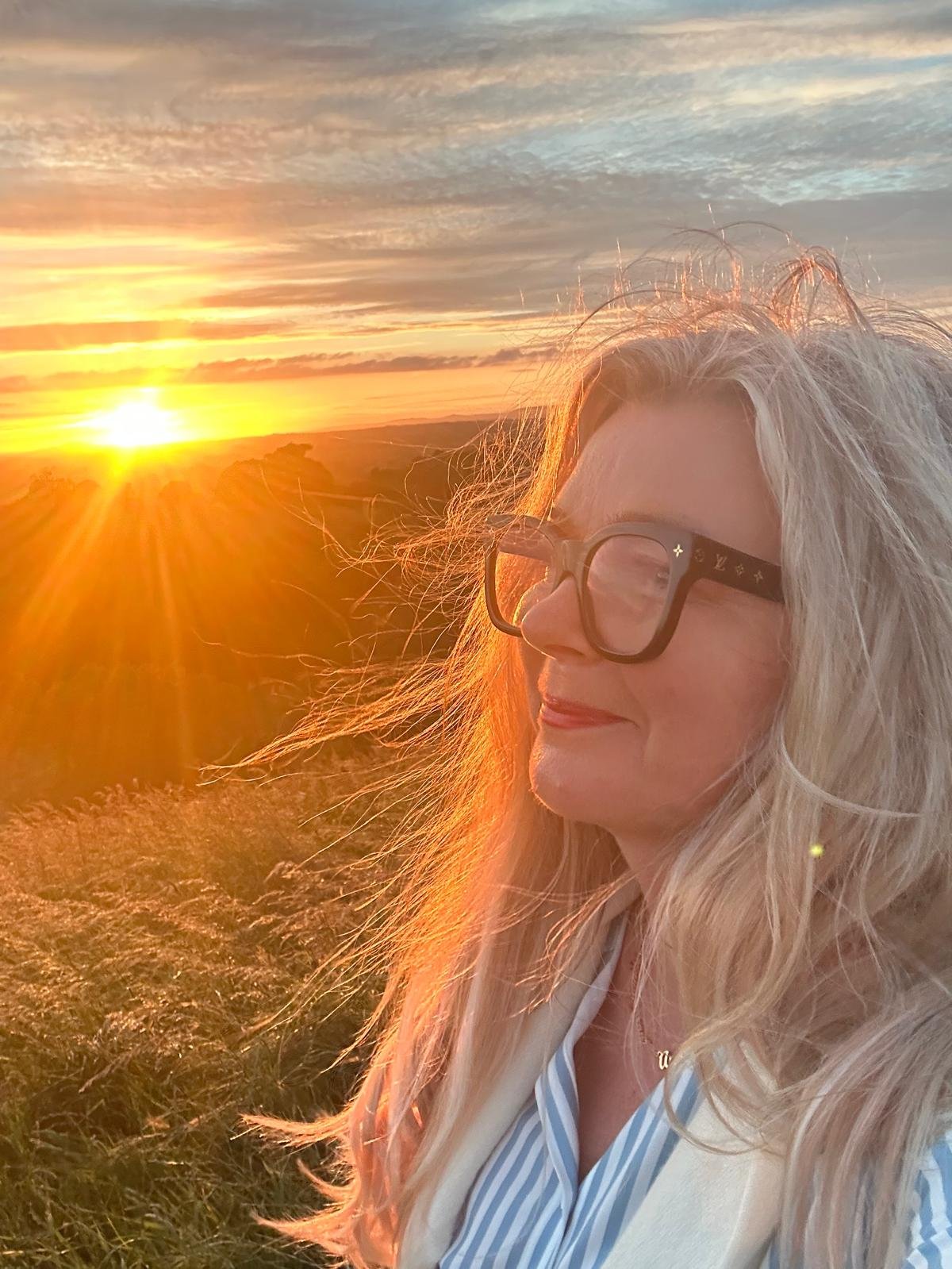 The Galactic High Priestess in profile against a golden sunset
