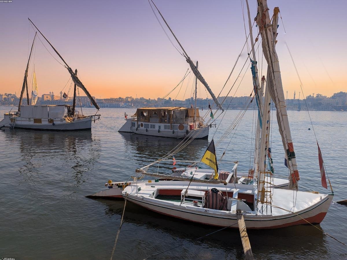 Traditional felucca sailboats resting on the Nile at dusk