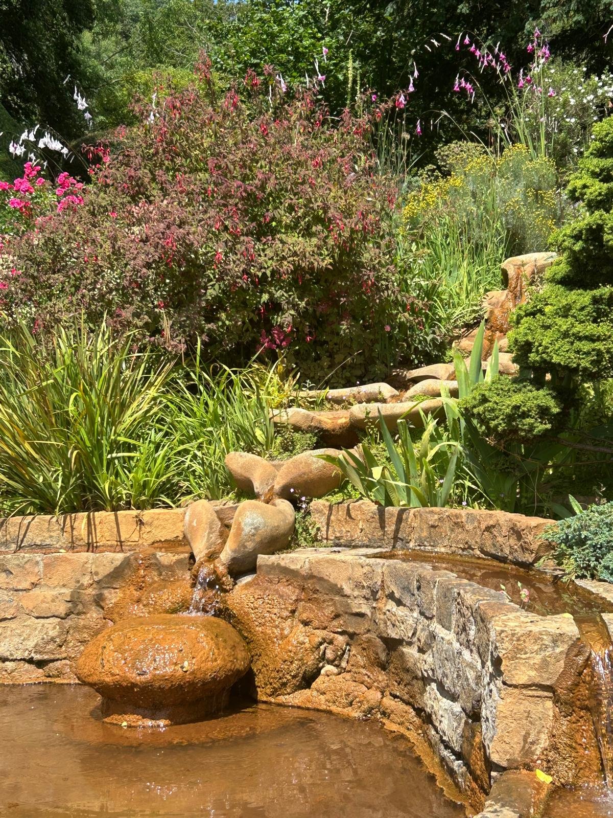 Chalice Well gate — Vesica Piscis well-lid with yellow flowers